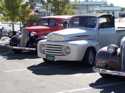 1972 Ford Ranchero - A white pickup truck is parked in a lot with other vintage vehicles.