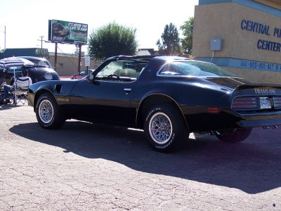 1972 Ford Ranchero - A black Pontiac Trans Am is parked in front of the Central Public Library.