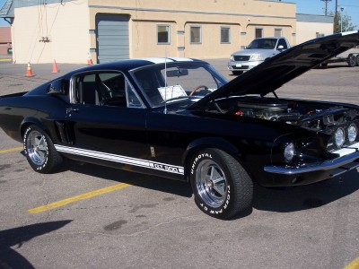 1972 Ford Ranchero - A black 1967 Ford Mustang Shelby GT500 is displayed with its hood open, revealing the engine bay.