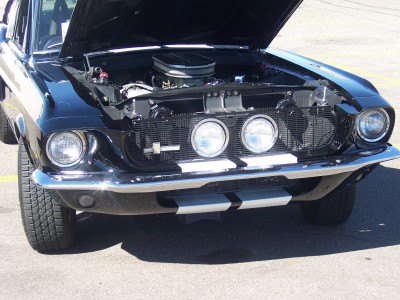 1972 Ford Ranchero - Front view of a black 1969 Ford Mustang Mach 1, hood open, revealing the engine.