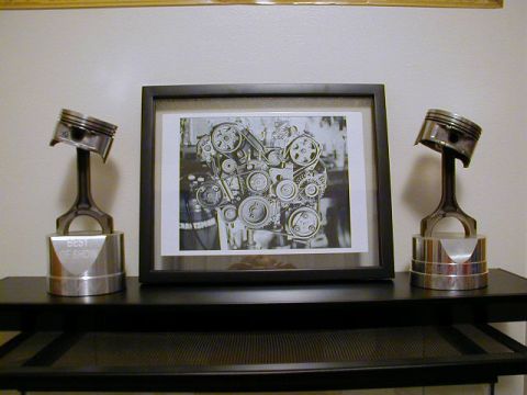 1994 Ford Probe - A framed photograph displays a complex engine component, with two 'Best of Show' trophies made from pistons on either side.