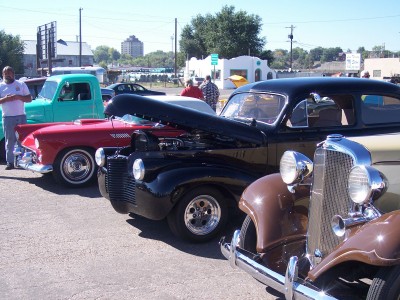 1972 Ford Ranchero - A row of vintage automobiles are displayed outdoors on a sunny day.