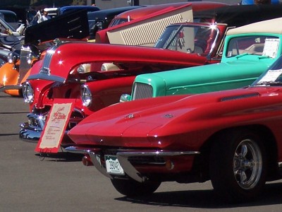 1972 Ford Ranchero - A line of vintage automobiles are parked together, with a red Corvette prominently displayed.