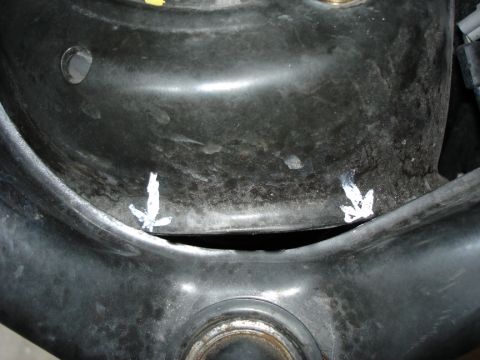 2005 Nissan Titan - Suspension component with white marks, possibly for alignment or modification reference.