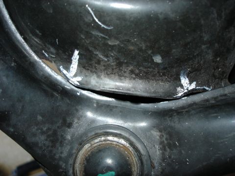 2005 Nissan Titan - Detail of a suspension component, possibly modified, showing white paint markings and a visible gap.