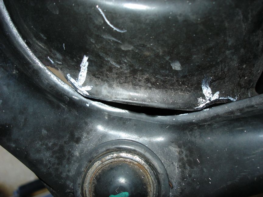 Close-up of scraped black plastic bumper panel with gouged seam