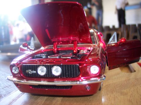 1972 Ford Ranchero - A shiny red toy car, possibly a 1967 Shelby GT500 KR, is displayed with its hood and driver's door open.