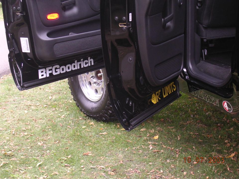 Black SUV doors open, showing BFGoodrich and OFF LIMITS decals on the rocker panels