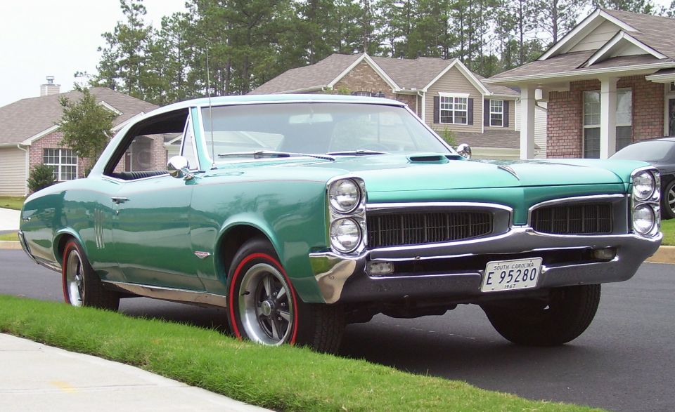 1967 Pontiac Lemans coupe, green, parked on street with redline tires