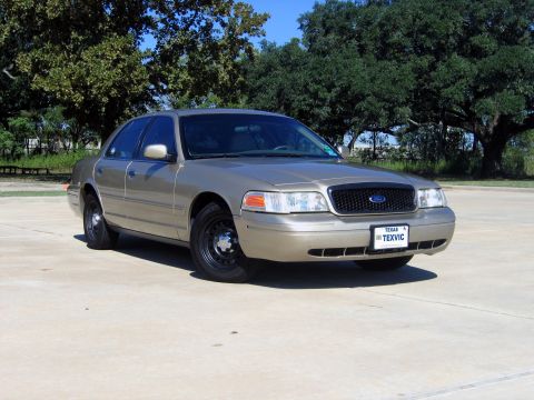 2000 Ford Crown Victoria - 2000 Ford Crown Victoria sedan in gold with black grille and steel wheels.