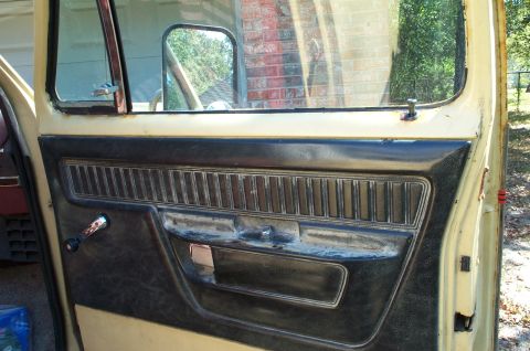 1978 Dodge Power Ram - Interior door panel view of a 1978 Dodge Power Ram, showing the door handle and window crank.