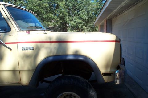 1978 Dodge Power Ram - This Dodge pickup truck, likely from the early to mid-1970s, is parked beside a garage door.