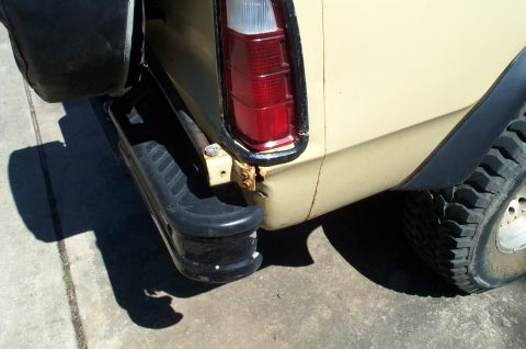 1978 Dodge Power Ram - The rear of a yellow truck shows a black bumper and fender flare.