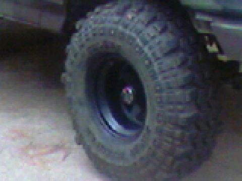 1988 Ford Bronco - Off-road tire and wheel detail with Supermotors.net watermark.