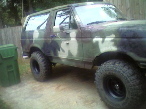 1988 Ford Bronco - This Ford Bronco is painted in a camouflage pattern and equipped with large off-road tires.