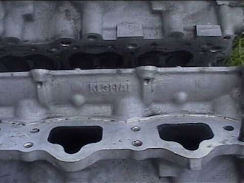 1994 Ford Probe - This image shows a section of an engine block with visible casting marks and bolt holes.