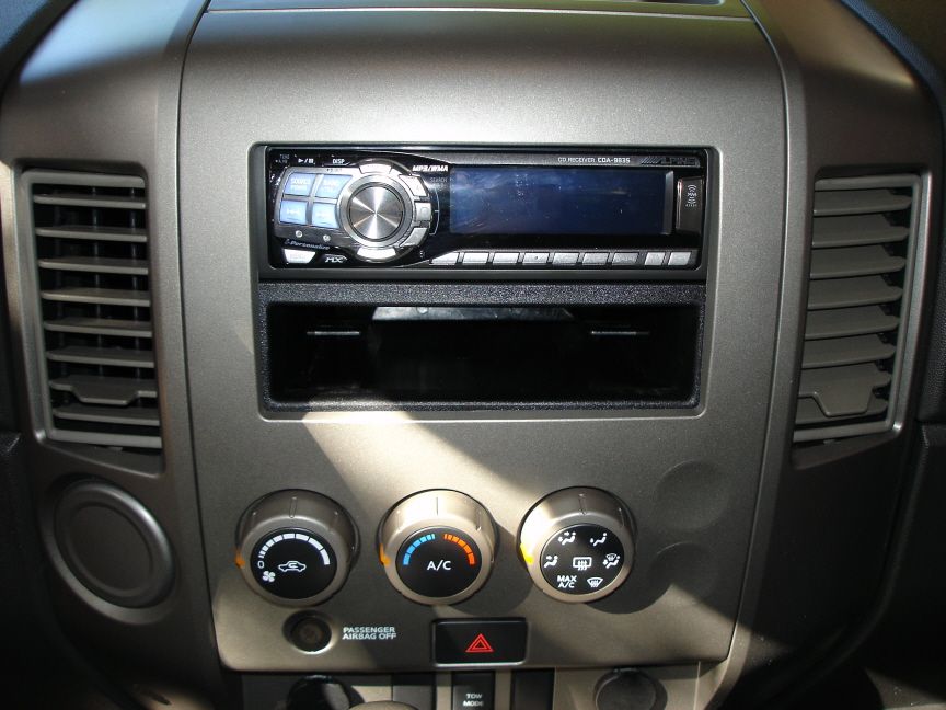Alpine CDA-9835 CD receiver in truck dash above rotary climate control knobs