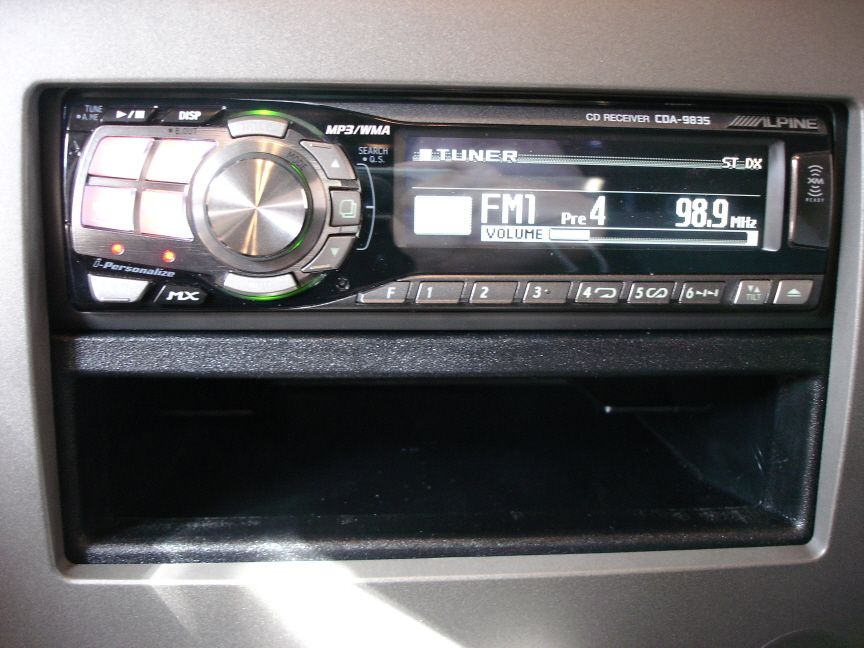 Alpine CDA-9835 CD receiver in gray dash showing FM1 98.9 MHz