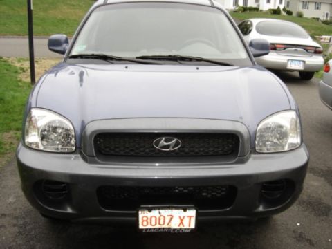 1999 Ford Taurus - Front view of a Hyundai Santa Fe, with a Ford Taurus visible in the background.
