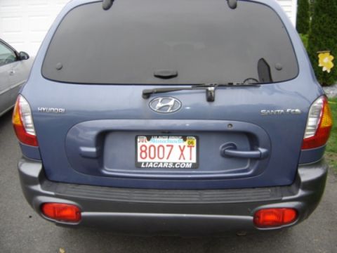 1999 Ford Taurus - Rear view of a blue Hyundai Santa Fe, a Massachusetts license plate.