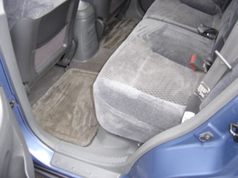 1999 Ford Taurus - Interior view of a blue vehicle, highlighting the rear seating area and floor mats.