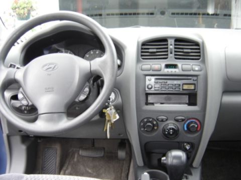 1999 Ford Taurus - Dashboard and steering wheel of a Hyundai Santa Fe, likely from the early 2000s.