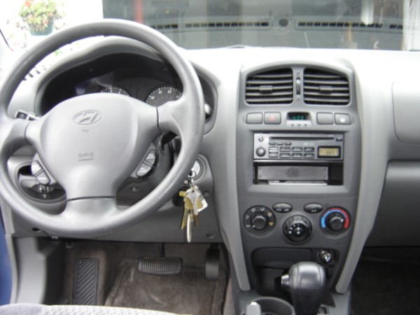 Interior view of a Hyundai Santa Fe showing the steering wheel, dashboard, and center console with radio