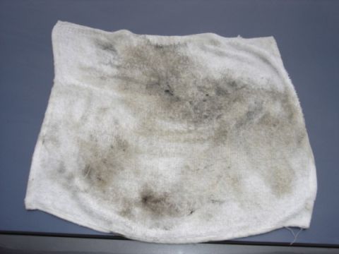 1999 Ford Taurus - This is a stained rag, likely used for cleaning up automotive fluids.
