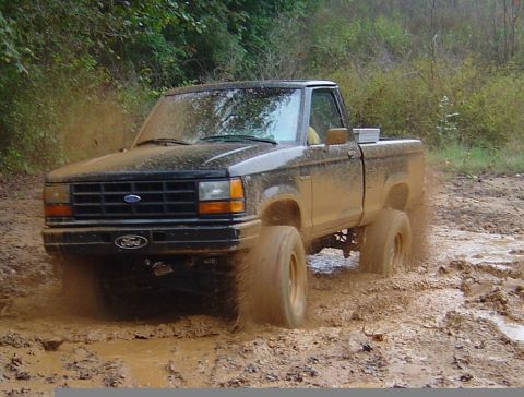 1989 Ford Ranger - This 1989 Ford Ranger is navigating a muddy trail, demonstrating its off-road capabilities.