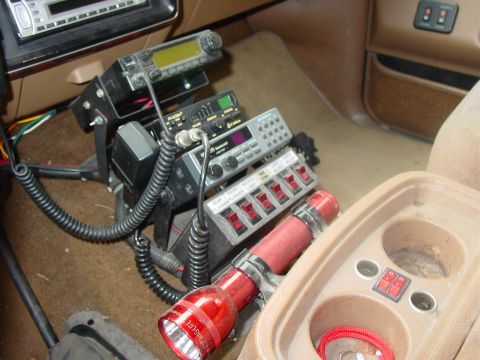 1989 Ford Bronco - Drivers side view of the custom radio rack, radios, switch box, flashlight, 12vt outlets.