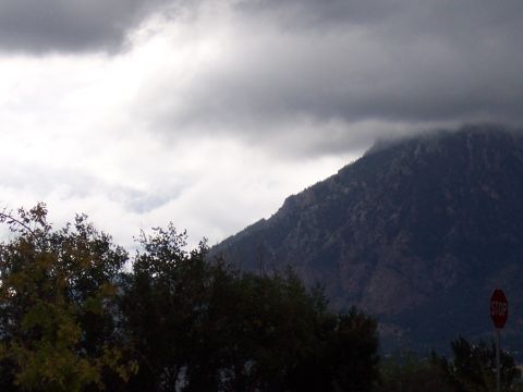 1972 Ford Ranchero - A stop sign is visible in the foreground, with a mountain and cloudy sky in the background.