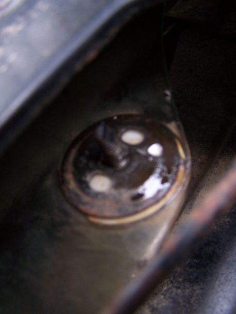 1979 Ford F-150 - A close-up view of a corroded bolt and washer, suggesting wear and tear on a vehicle component.