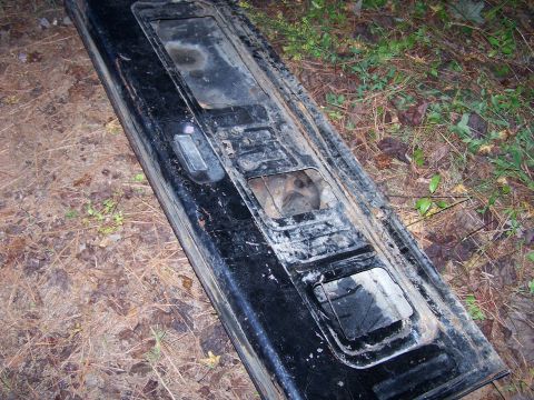 1979 Ford F-150 - This is a part of a vehicle's tailgate, lying on the ground.