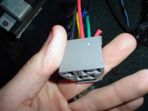 1984 Ford Bronco - A close-up view of a vehicle's wiring harness connector with several colored wires.