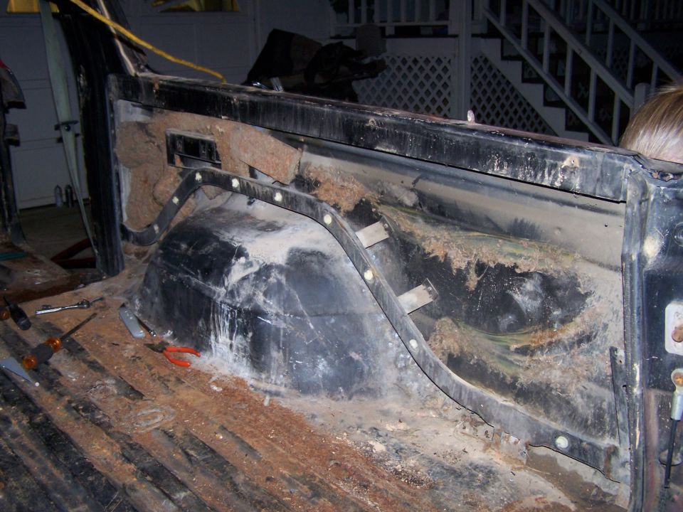 1979 Ford F-150 interior showing rust and exposed insulation in the truck bed