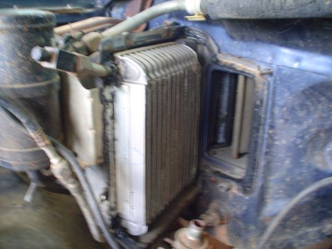 1984 Ford Bronco - Close-up of a vehicle's heater core, likely during a repair or replacement process.