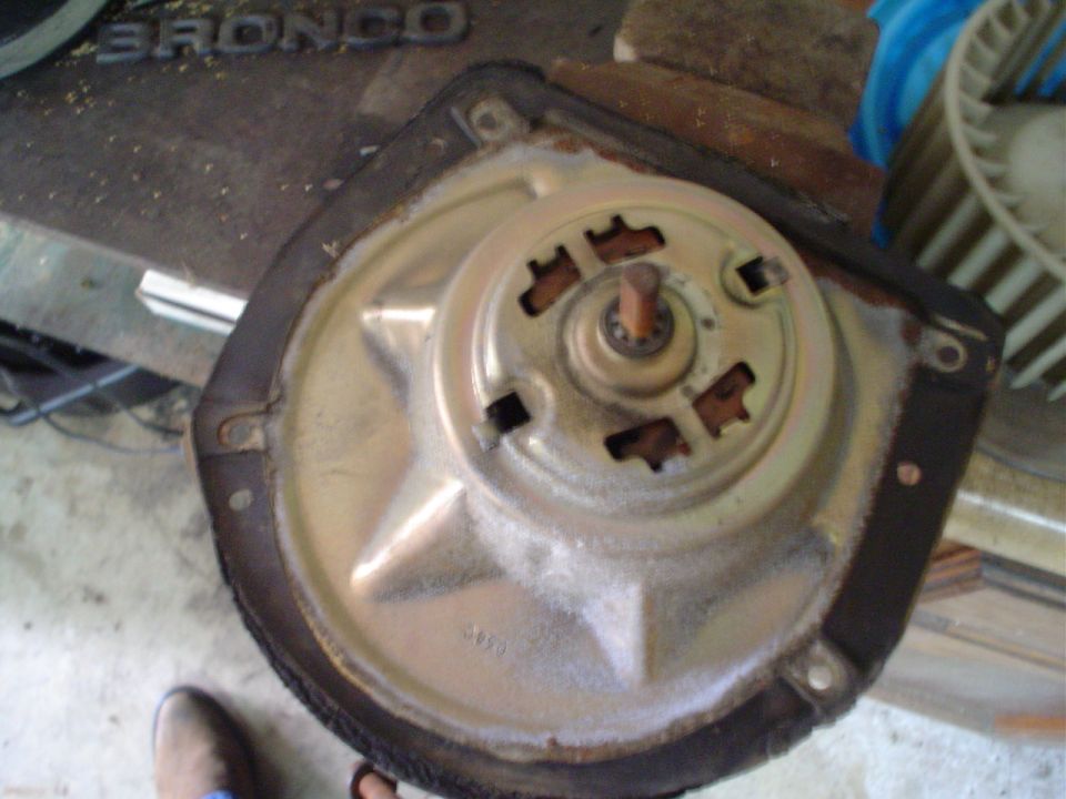 blower motor assembly with metal housing and plastic fan visible