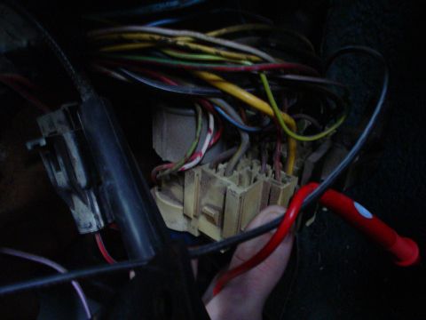 1984 Ford Bronco - A tangled mess of wires and a fuse box are visible inside the vehicle's interior.