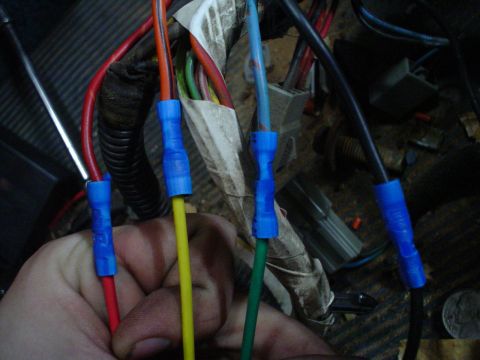 1984 Ford Bronco - Close-up of a vehicle's interior wiring harness with multiple colored wires and blue connectors.