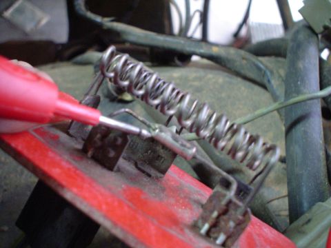 1984 Ford Bronco - A vehicle's heater resistor coil is examined with a red probe, likely during a diagnostic or repair process.