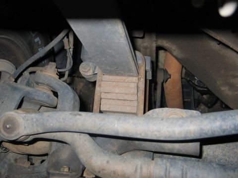 1995 Ford Bronco - This image shows the underside of a vehicle, focusing on the suspension system with leaf springs and control arms visible.