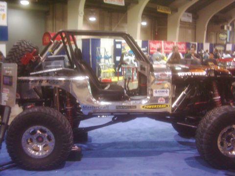 1978 Ford Bronco - Custom off-road vehicle with extensive modifications and roll cage displayed indoors.