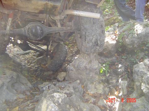 1986 Ford Bronco - An off-road vehicle's undercarriage is visible as it maneuvers over a rocky obstacle course.