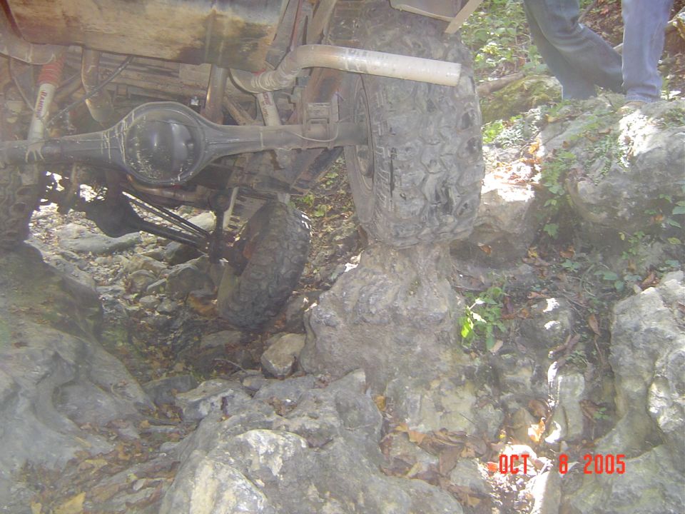 Undercarriage of an off-road vehicle navigating rocky terrain
