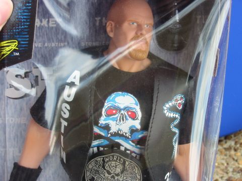 1991 Ford Bronco - Action figure of Stone Cold Steve Austin in packaging, with text visible on the shirt and belt.