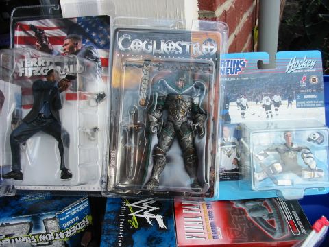 1991 Ford Bronco - A display of various collectible action figures and hockey-themed merchandise, including a Terry Fitzgerald figure and a Cogliostro figure.
