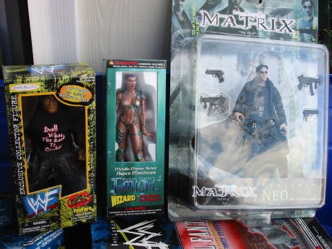 1991 Ford Bronco - A display of collectible action figures, including The Rock, Aspen Matthews, and Neo from The Matrix.