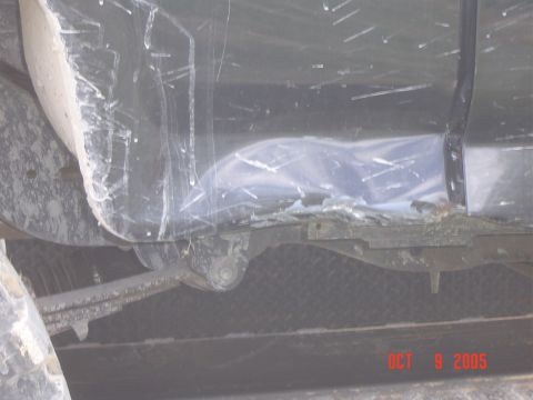 1986 Ford Bronco - The underside of a vehicle shows damage and wear, with a watermark indicating the photo was taken on October 8, 2005.