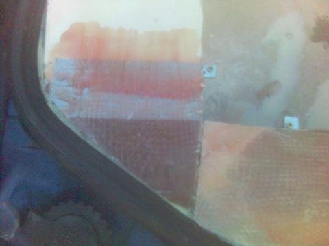 1994 Ford Probe - Close-up of an interior panel showing layered colors and visible mounting hardware.