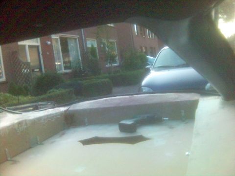 1994 Ford Probe - View from inside a car shows a blue car and a residential building.